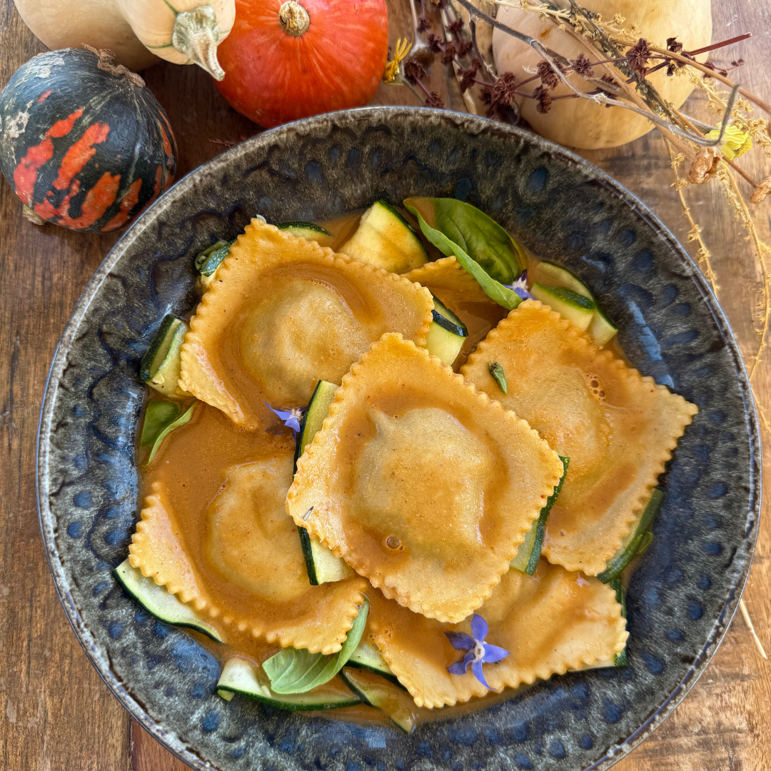 Ossobuco ravioli with sauce and roasted vegetables.