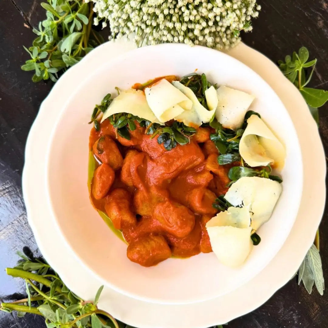 Sweet potato and cheese gnocchi, roasted bell pepper sauce.