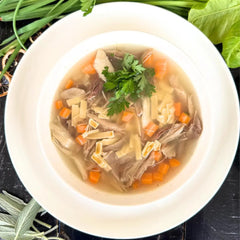 Chicken soup with vegetables and fresh pasta.
