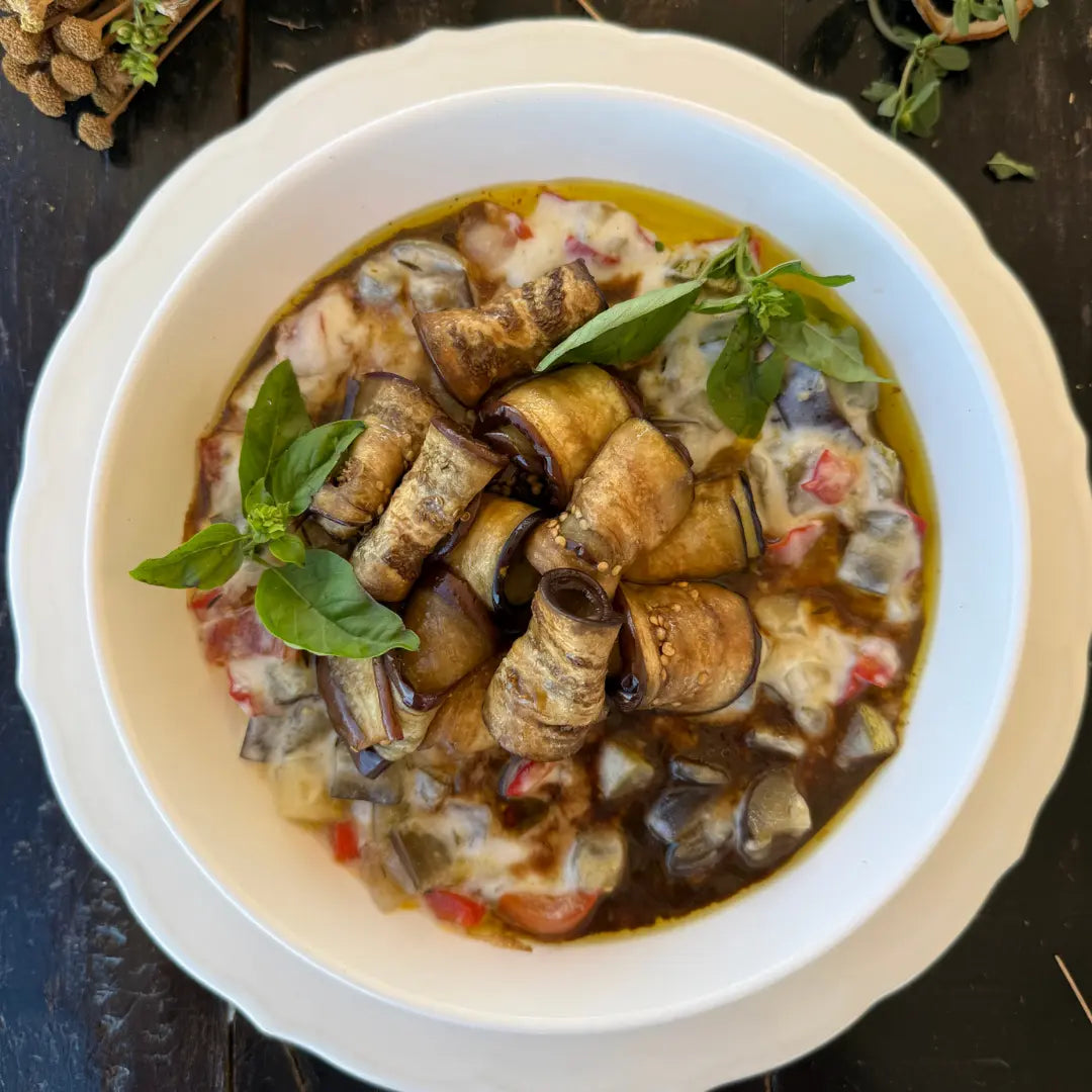 Eggplant rolls, bed of stewed vegetables, and Mornay sauce