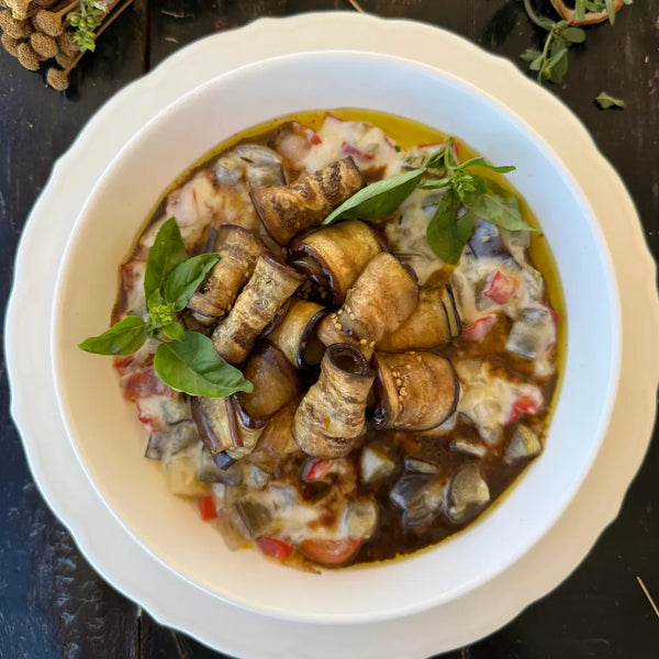 Eggplant rolls, bed of stewed vegetables, and Mornay sauce