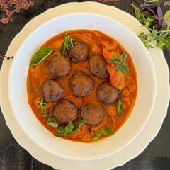 Tomato tagliatelle, roasted bell pepper sauce, and mini bean meatballs.