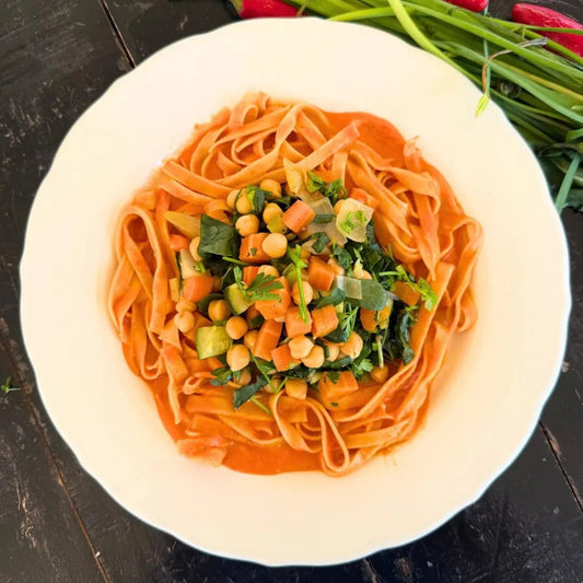 Fresh tagliatelle, bell pepper sauce and sautéed vegetables.