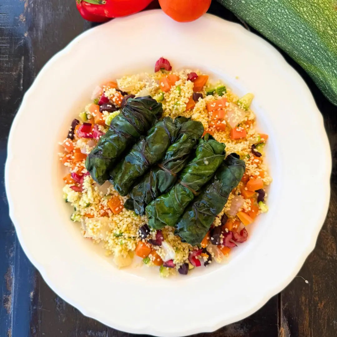 Chard rolls with roasted onion and cheese mixed with vegetable couscous